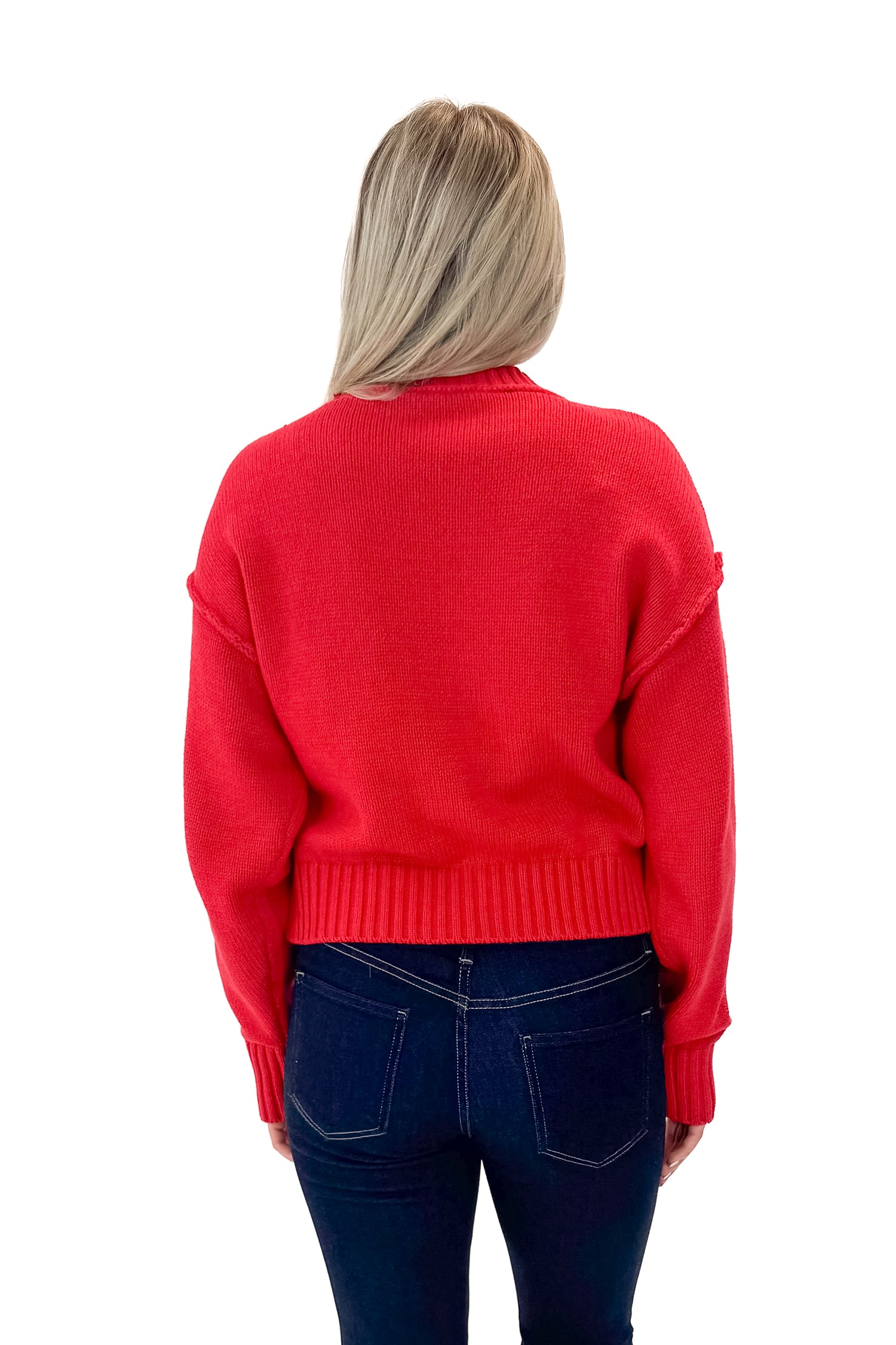 Back view of woman wearing Red Seam Split Detail Sweater with jeans against white studio background.