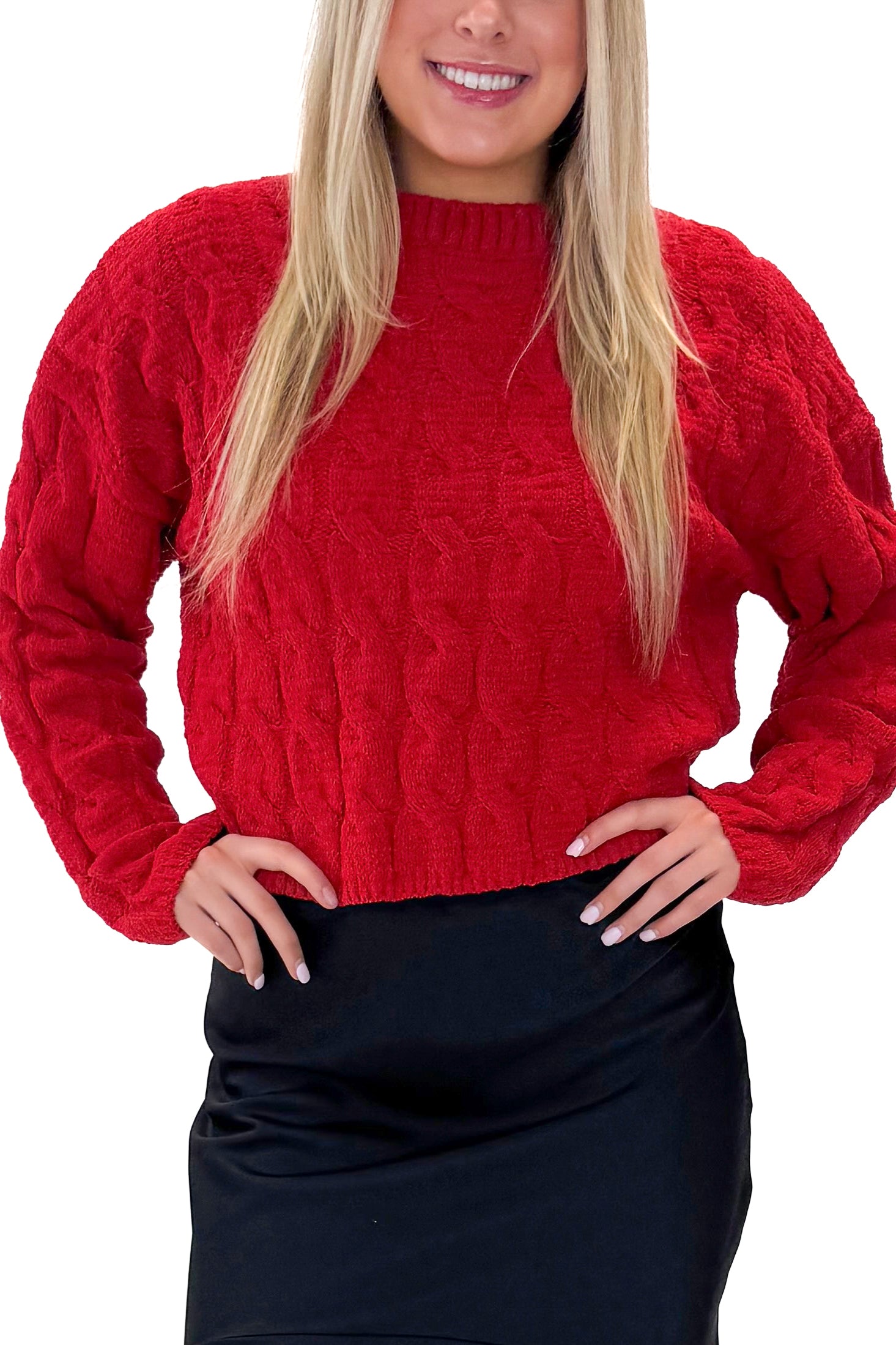 Front detail view of woman wearing Red Textured Cable Knit Sweater with skirt against white studio background.