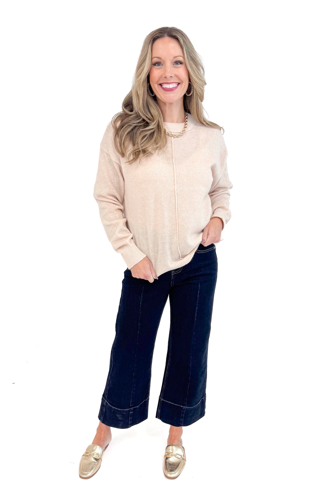 Woman wearing Light Taupe Center Seam Sweater and jeans.