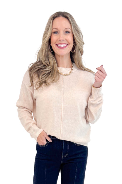 Woman wearing Light Taupe Center Seam Sweater and jeans. 