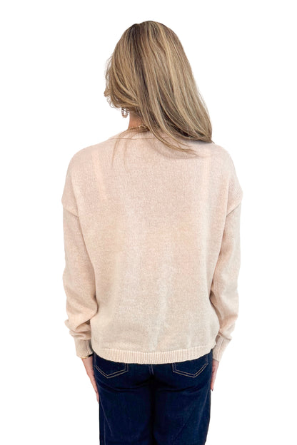 Back view of woman wearing Light Taupe Center Seam Sweater and jeans. 
