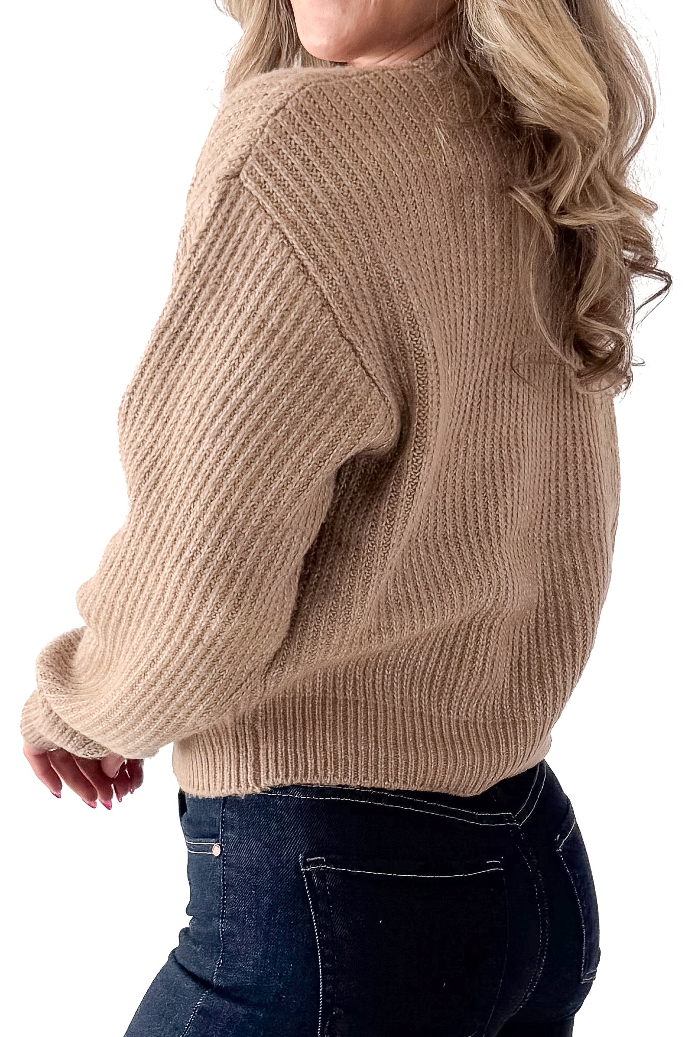 Side view of woman wearing Dark Taupe Ribbed Sweater with jeans against white studio background.