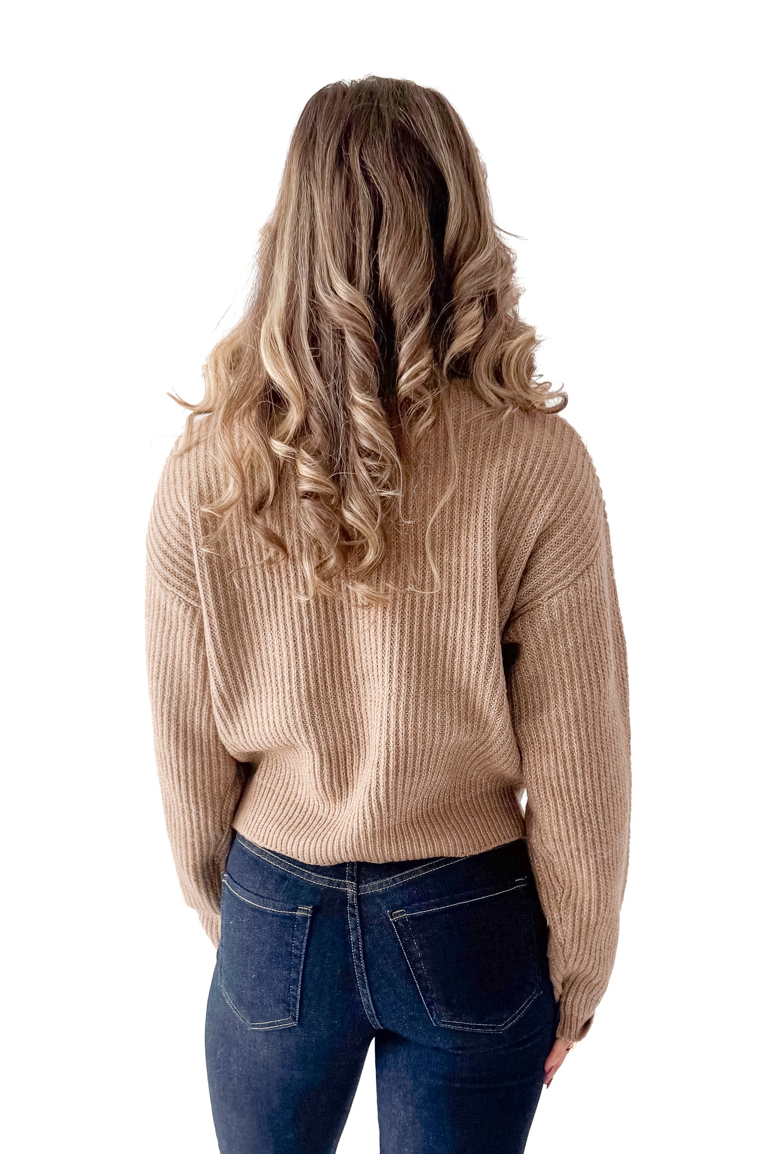 Back view of woman wearing Dark Taupe Ribbed Sweater with jeans against white studio background.