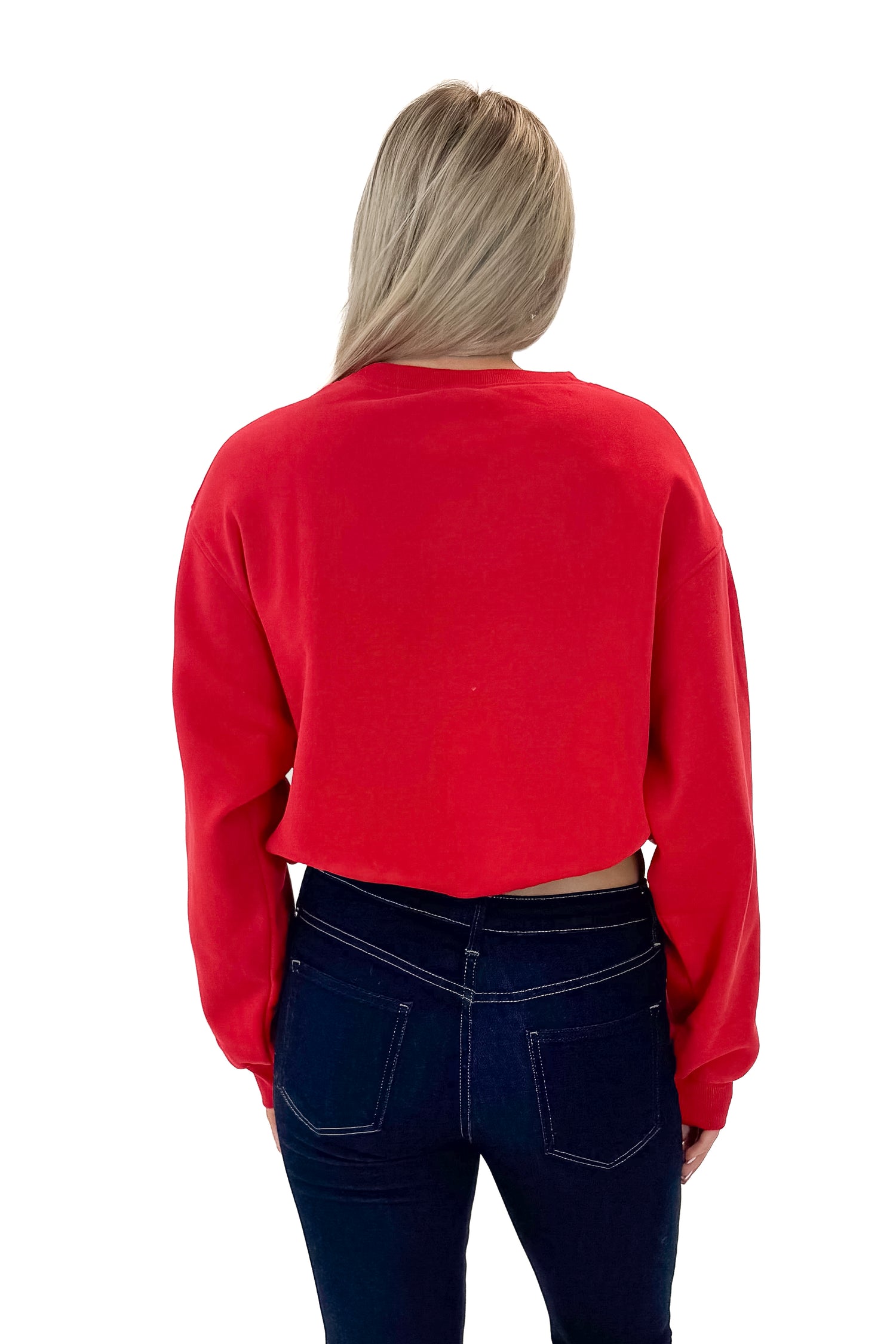 Back view of woman wearing Red Elastic Hem Sweatshirt with jeans against white studio background.