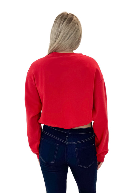 Back view of woman wearing Red Elastic Hem Sweatshirt with jeans against white studio background.