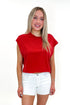 Front view of woman wearing Red Boxy Tee with jean shorts against white studio background.