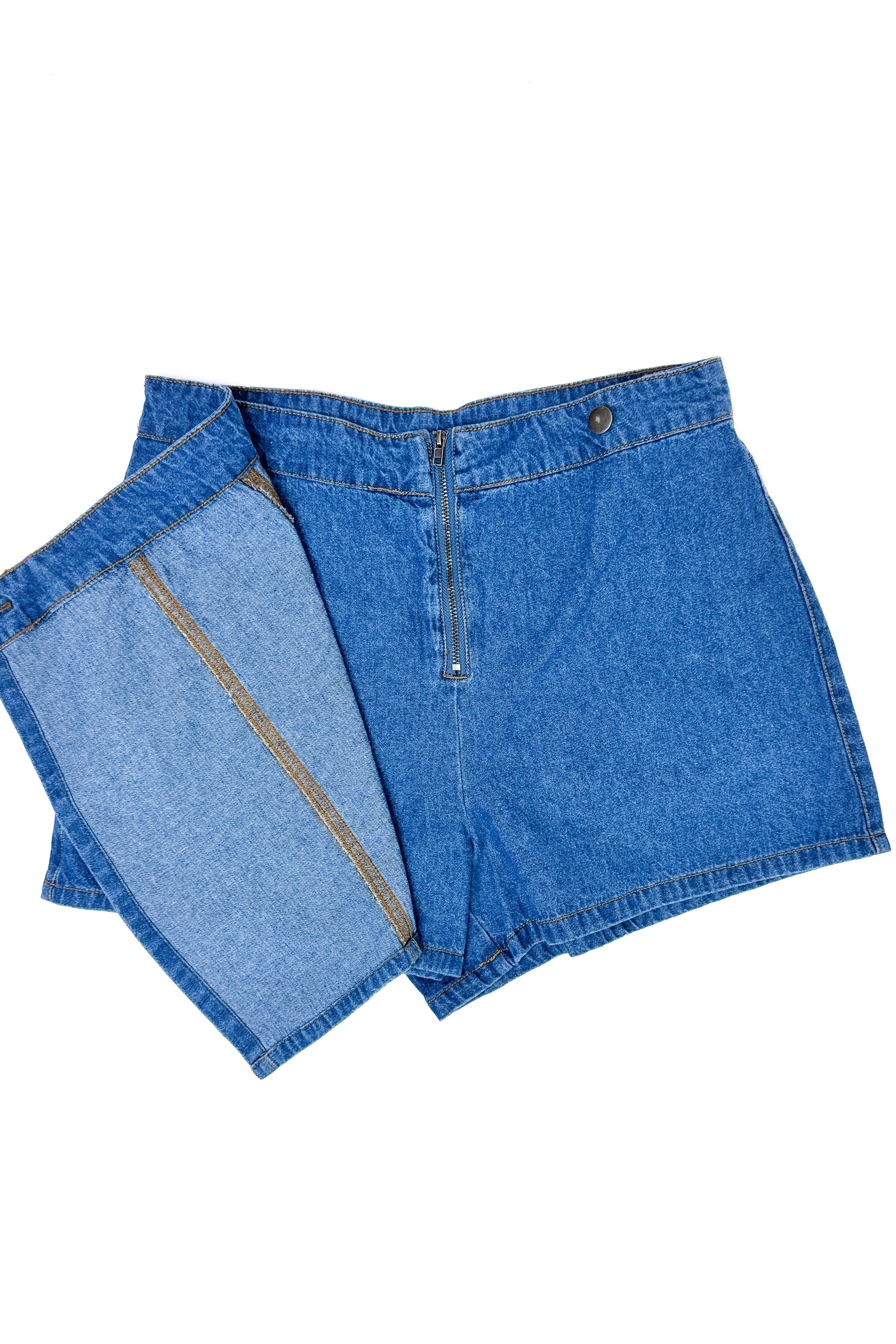 Flat lay of Medium Wash Denim Wrap Skort against white studio background.