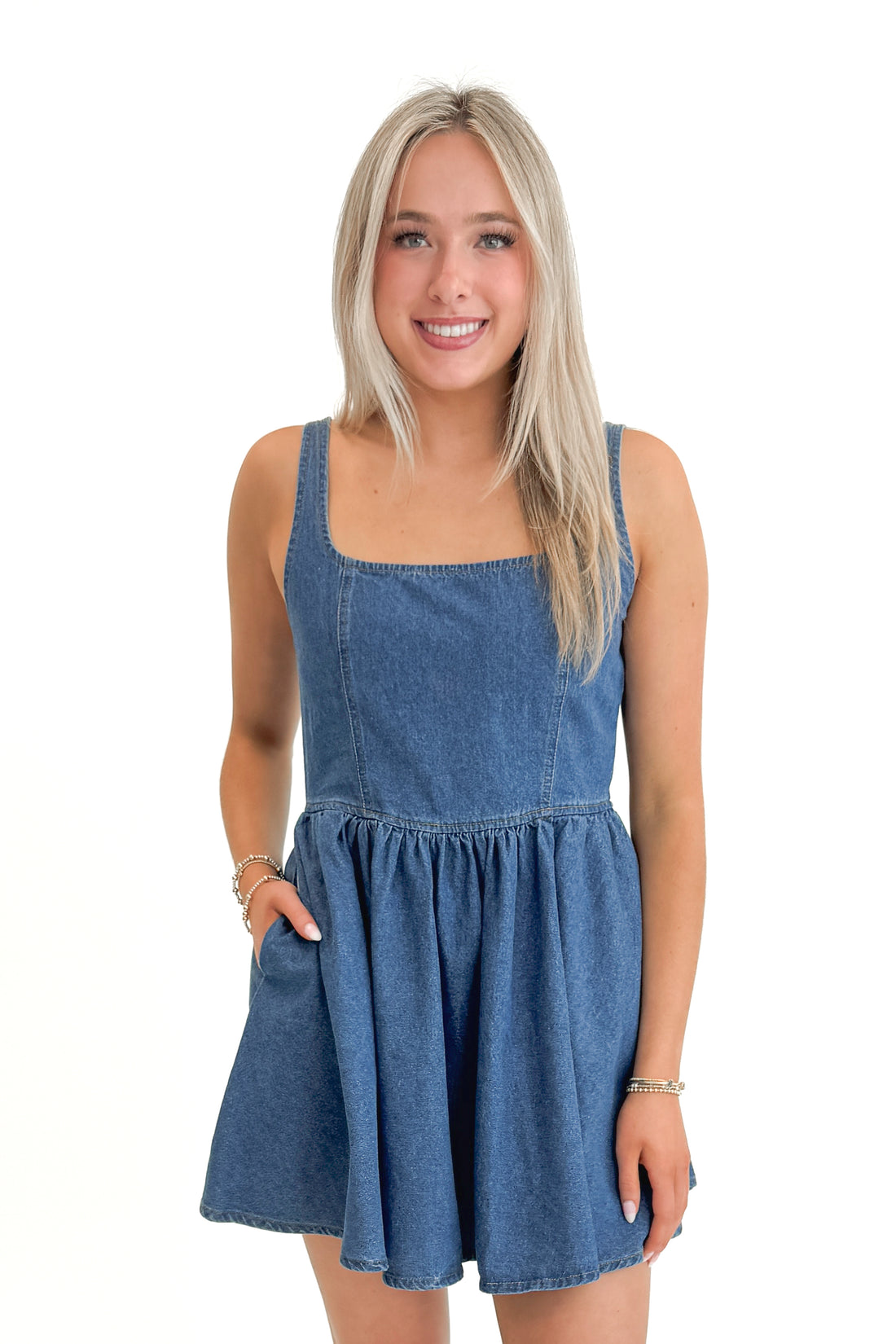 Front view of woman wearing Denim Tank Dress against white studio background.