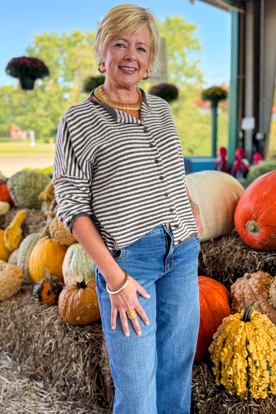 Front view of woman wearing Swagger Boutique’s Dark Brown &amp; Cream Striped Button Up Cardigan with jeans at a pumpkin patch.