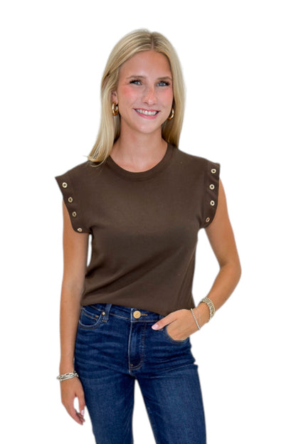 Front view of woman wearing Swagger Boutique’s Dark Chocolate Camino Grommet Top by Z Supply with jeans against white studio background.