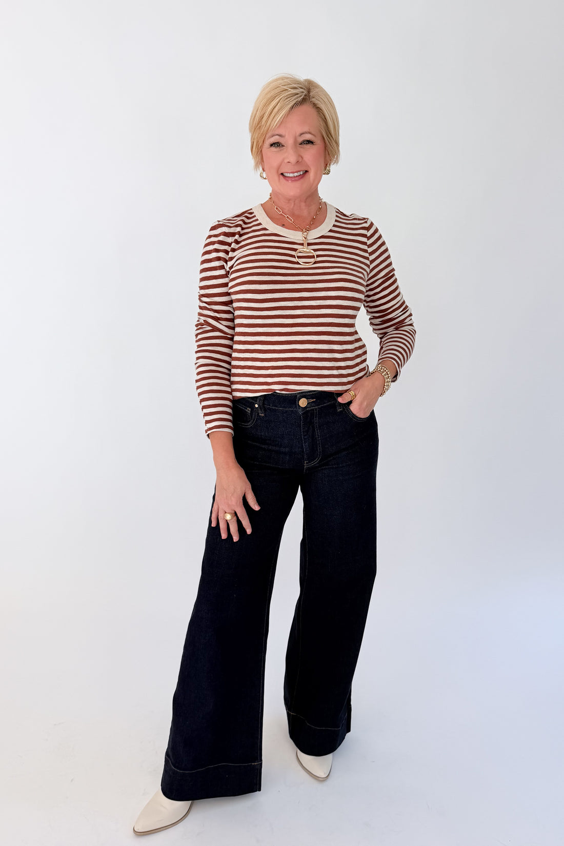 Front view of woman wearing Swagger Boutique’s Dark Rosewood Junie Long Sleeve Stripe Slub Tee by Z Supply with jeans against white studio background.