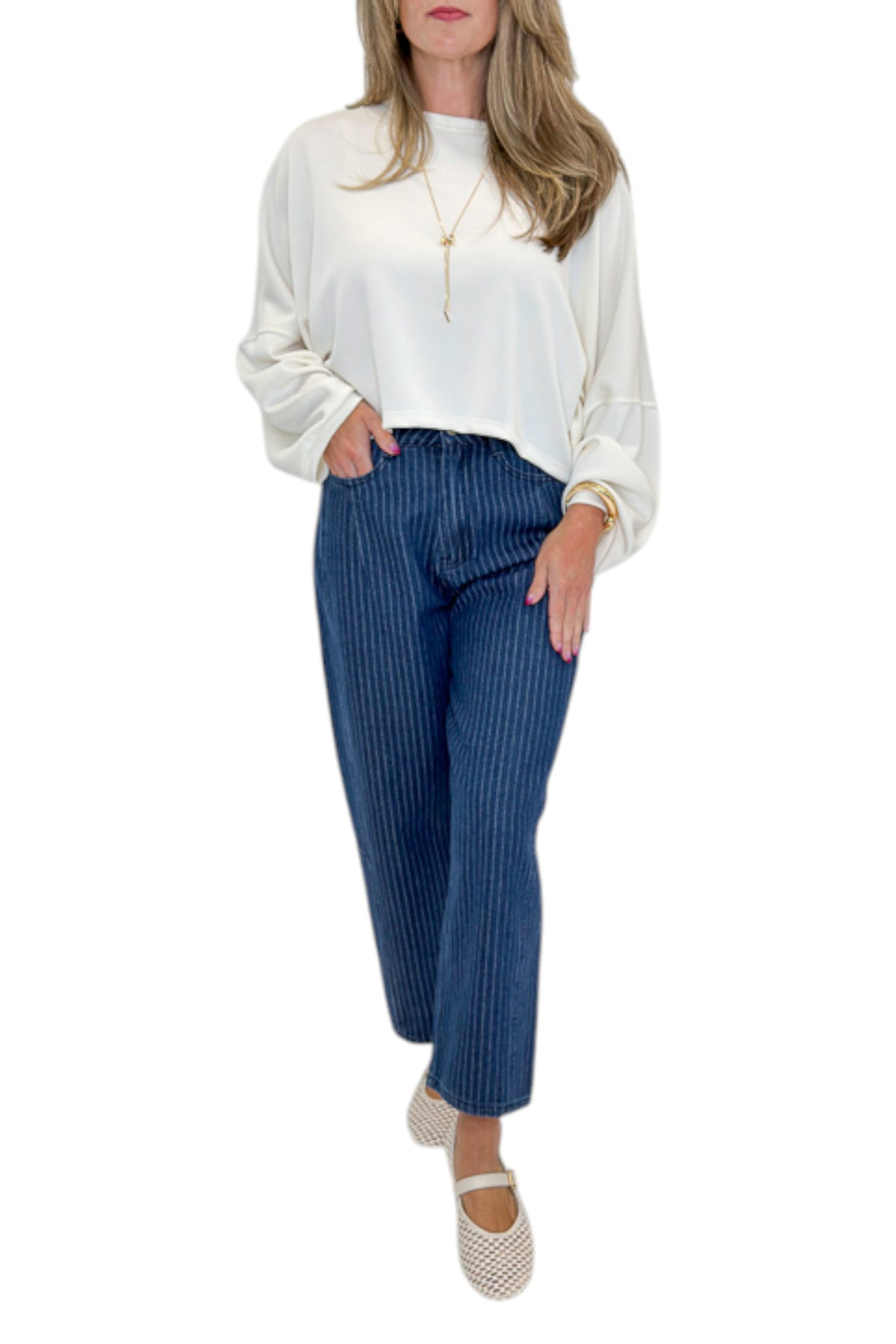 Front view of woman wearing Swagger Boutique’s Dark Wash Pinstriped Barrel Jeans with top against white studio background.