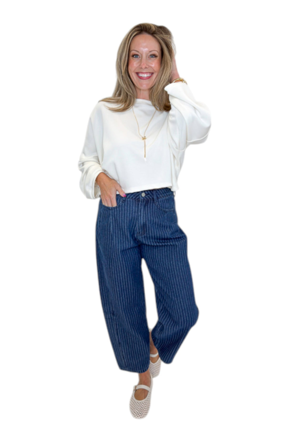 Front view of woman wearing Swagger Boutique’s Dark Wash Pinstriped Barrel Jeans with top against white studio background.