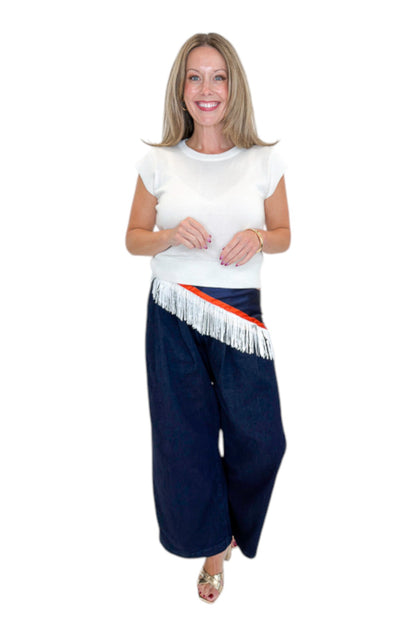 Front view of woman wearing Swagger Boutique’s Dark Wash Pleated Trouser Jeans by Risen with sweater &amp; scarf against white studio background.