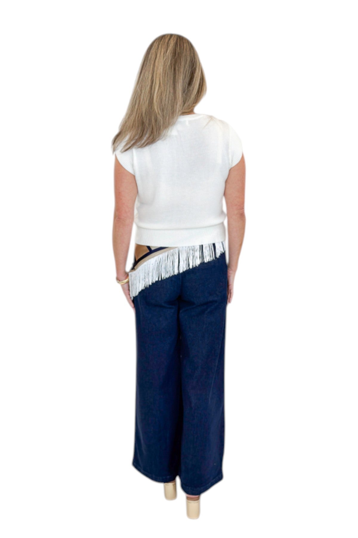 Back view of woman wearing Swagger Boutique’s Dark Wash Pleated Trouser Jeans by Risen with sweater &amp; scarf against white studio background.
