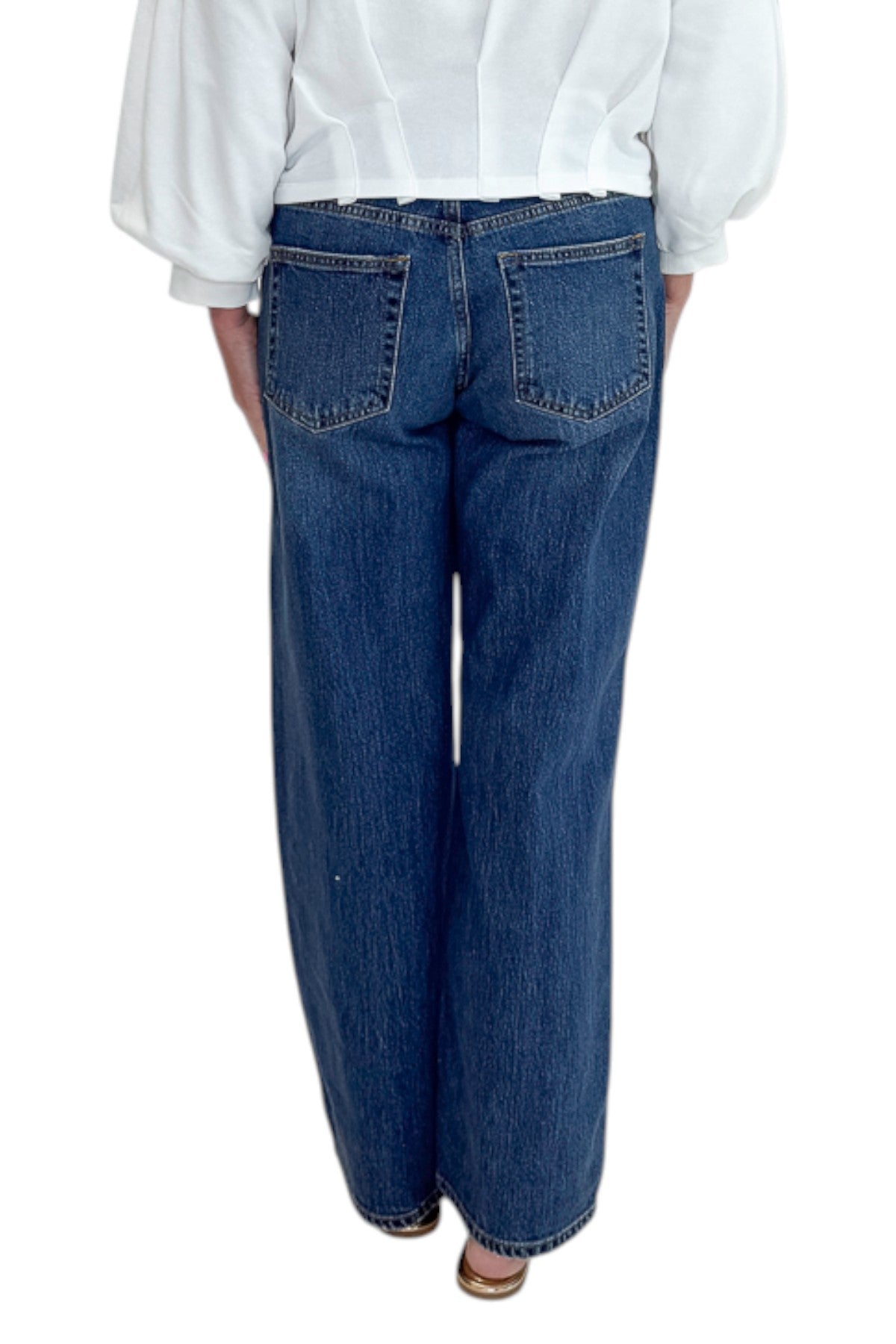 Back view of woman wearing Swagger Boutique’s sweater with Dark Wash Stud Jeans by Just Black Denim against white studio background.