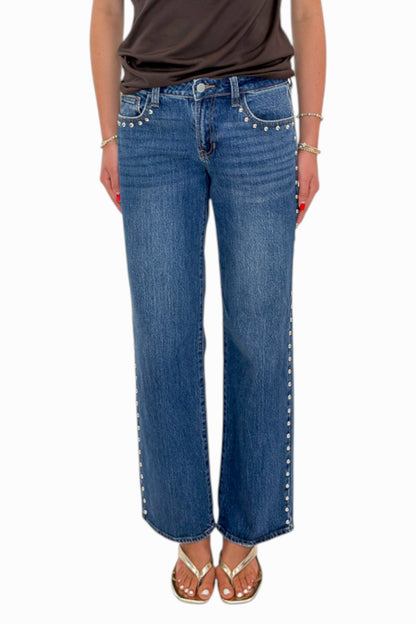 Front view of woman wearing Swagger Boutique’s Dark Wash Stud Jeans by Just Black Denim against white studio background.
