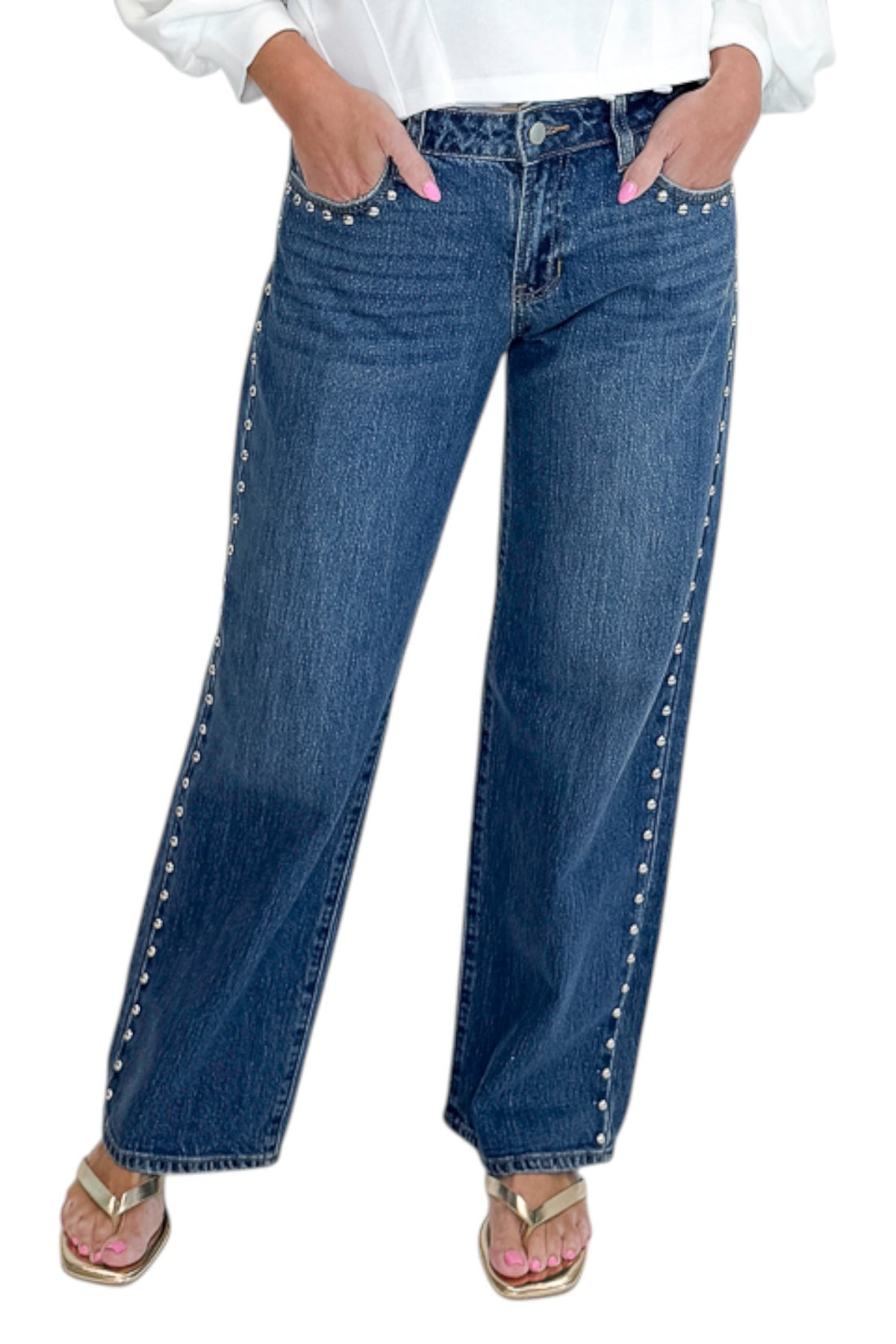 Front detail view of woman wearing Swagger Boutique’s sweater with Dark Wash Stud Jeans by Just Black Denim against white studio background.