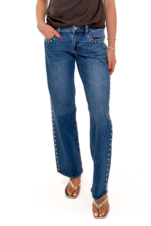 Front view of woman wearing Swagger Boutique’s Dark Wash Stud Jeans by Just Black Denim against white studio background.