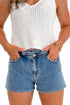 Front view of model wearing Denim Elastic Waist Shorts by Just Black Denim with white tank against white studio background. 