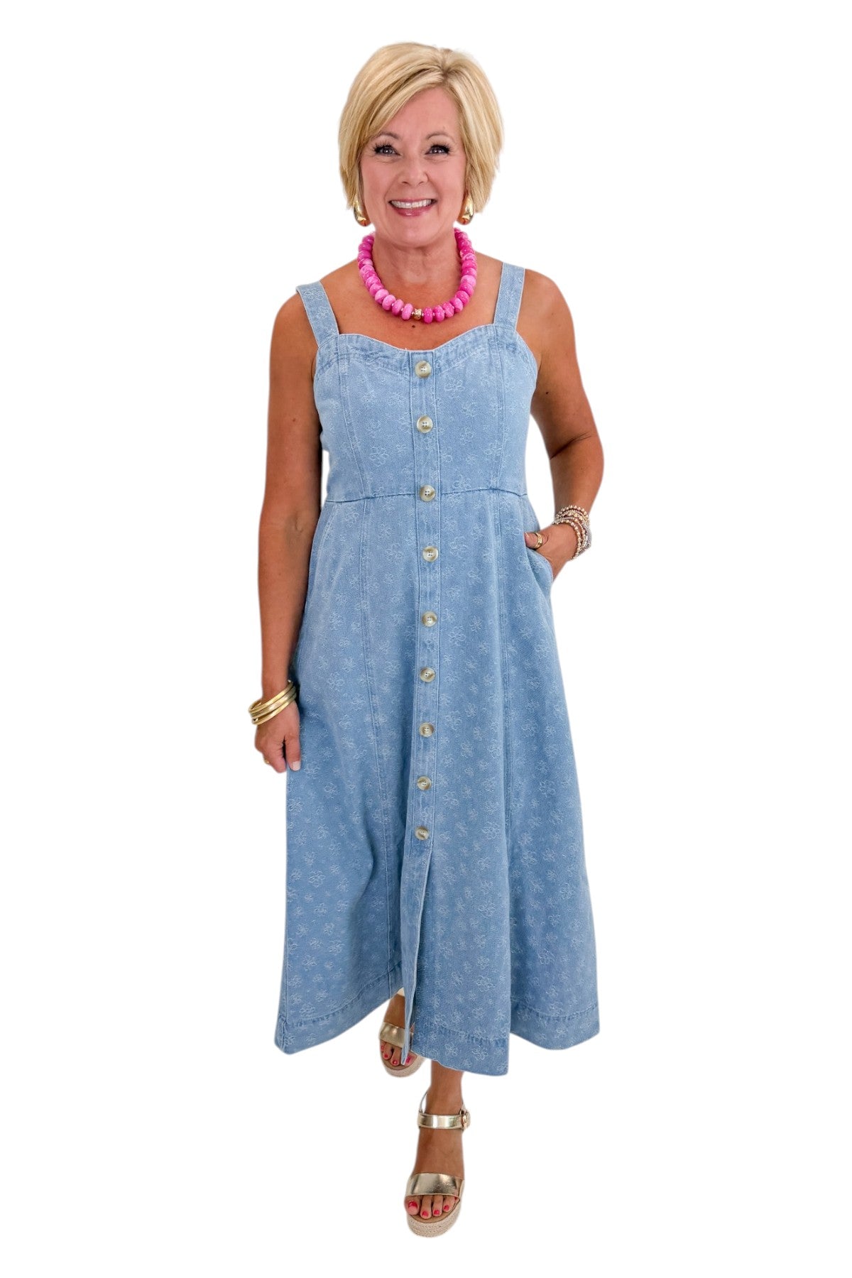 Front view of woman wearing Swagger Boutique’s Denim Floral Textured Midi Dress with wedges against white studio background.