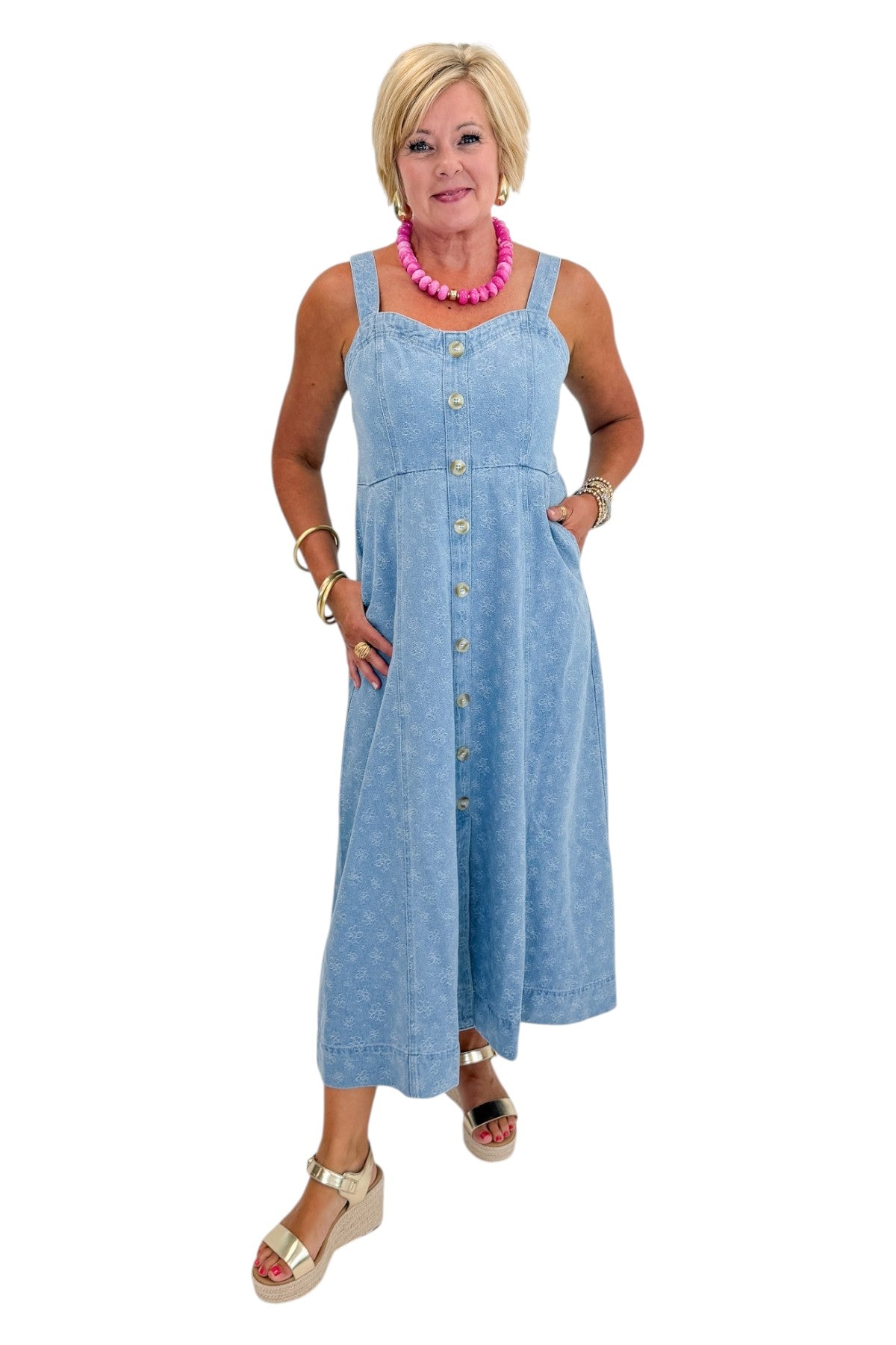 Front view of woman wearing Swagger Boutique’s Denim Floral Textured Midi Dress with wedges against white studio background.