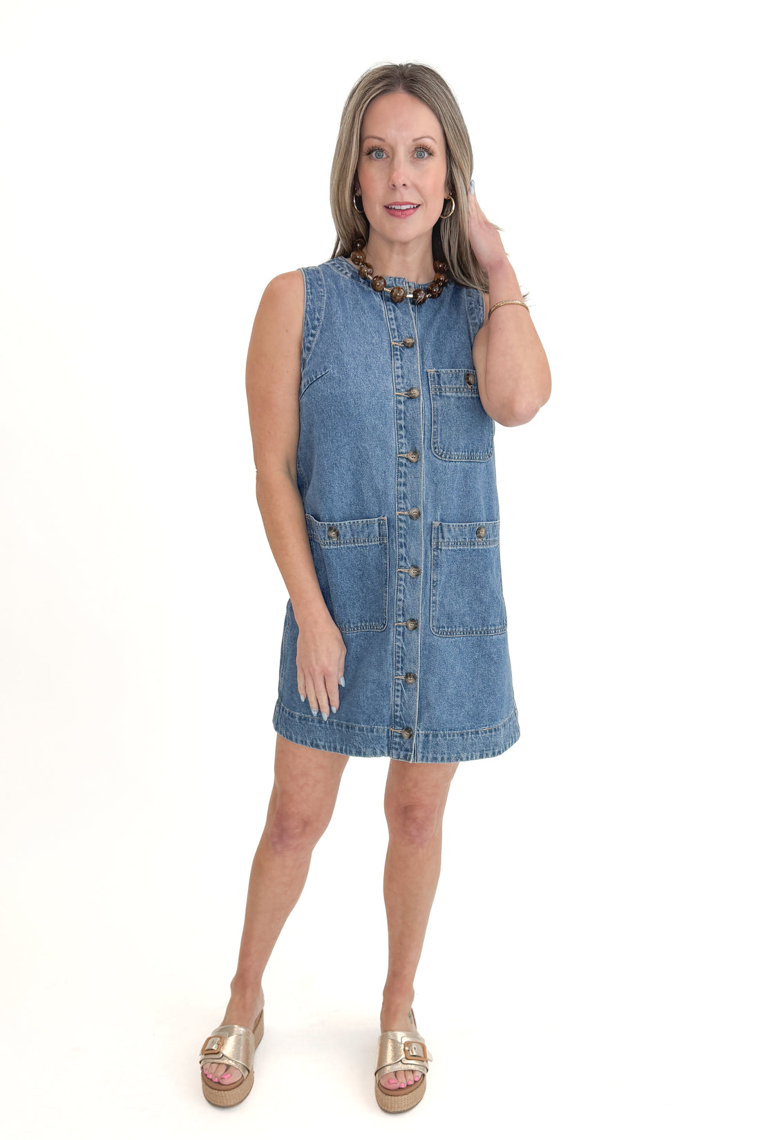 Front view of woman wearing Denim Pocket Detail Dress with sandals against white studio background.