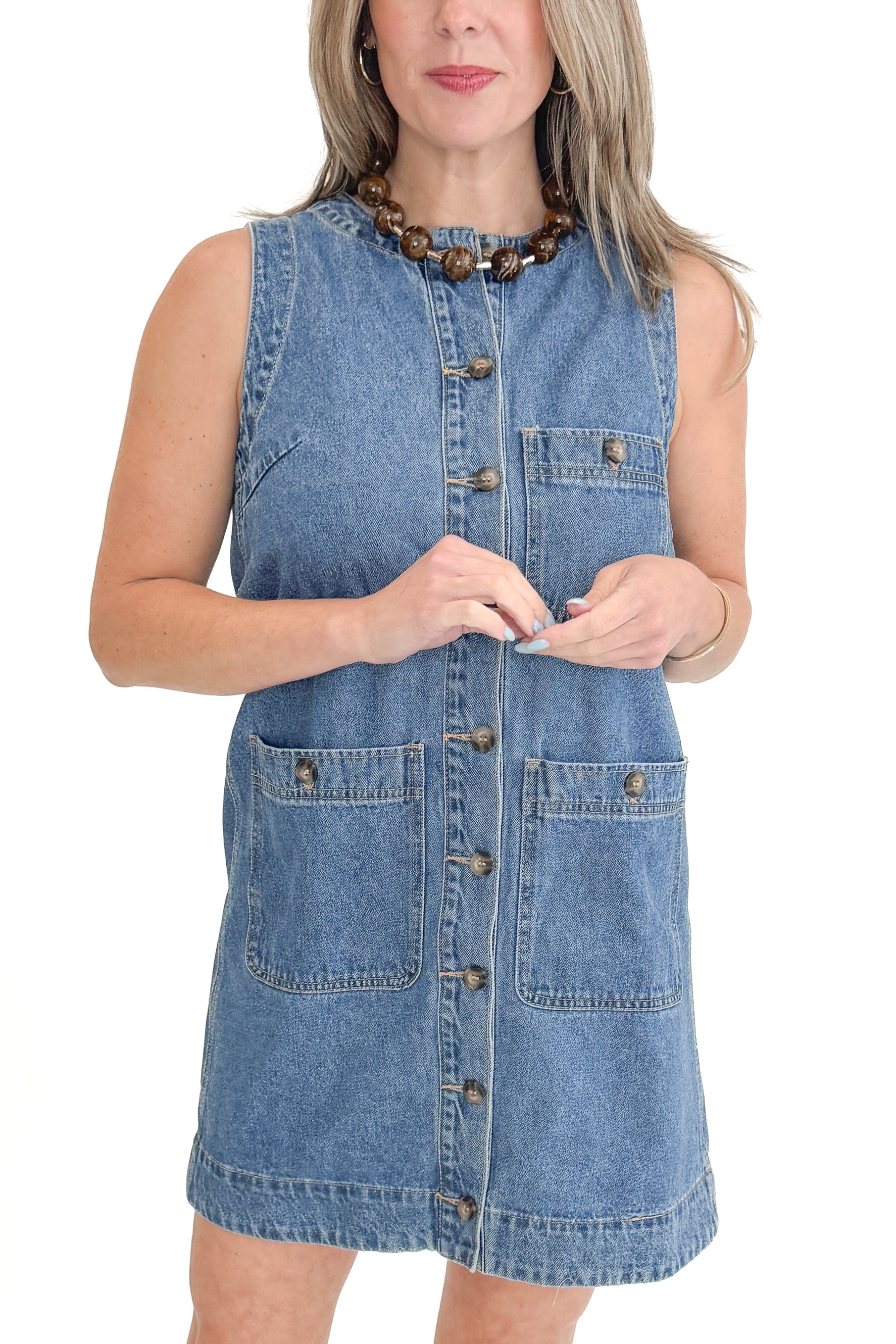 Front view of woman wearing Denim Pocket Detail Dress with sandals against white studio background.