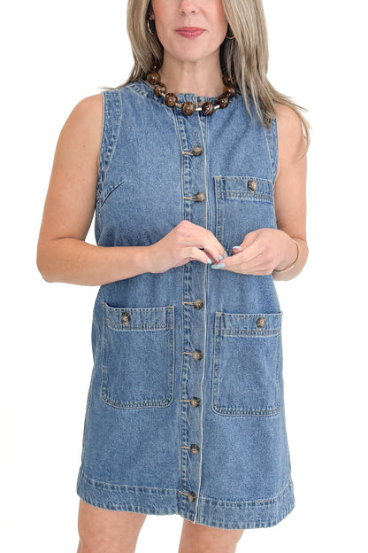 Front view of woman wearing Denim Pocket Detail Dress with sandals against white studio background.