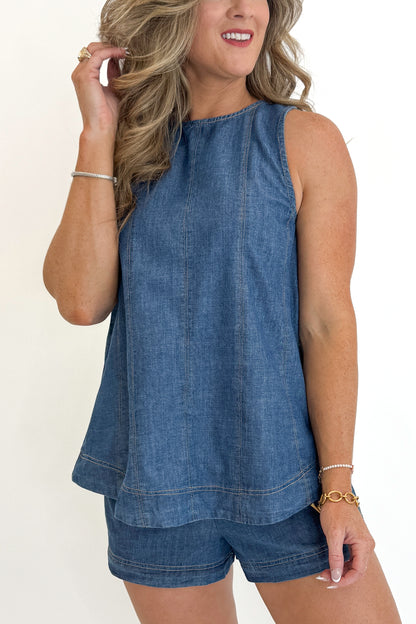 Front detail view of woman wearing Swagger Boutique’s Denim Seam Detail Swing Tank with matching Denim Seam Detail Shorts against white studio background.