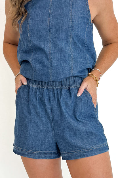 Front detail view of woman wearing Swagger Boutique’s Denim Seam Detail Swing Tank with matching Denim Seam Detail Shorts against white studio background.