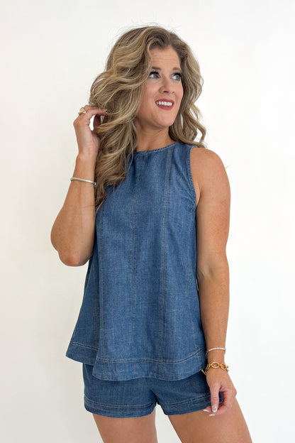 Front view of woman wearing Swagger Boutique’s Denim Seam Detail Swing Tank with matching Denim Seam Detail Shorts against white studio background.