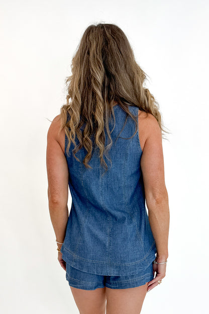 Back view of woman wearing Swagger Boutique’s Denim Seam Detail Swing Tank with matching Denim Seam Detail Shorts against white studio background.