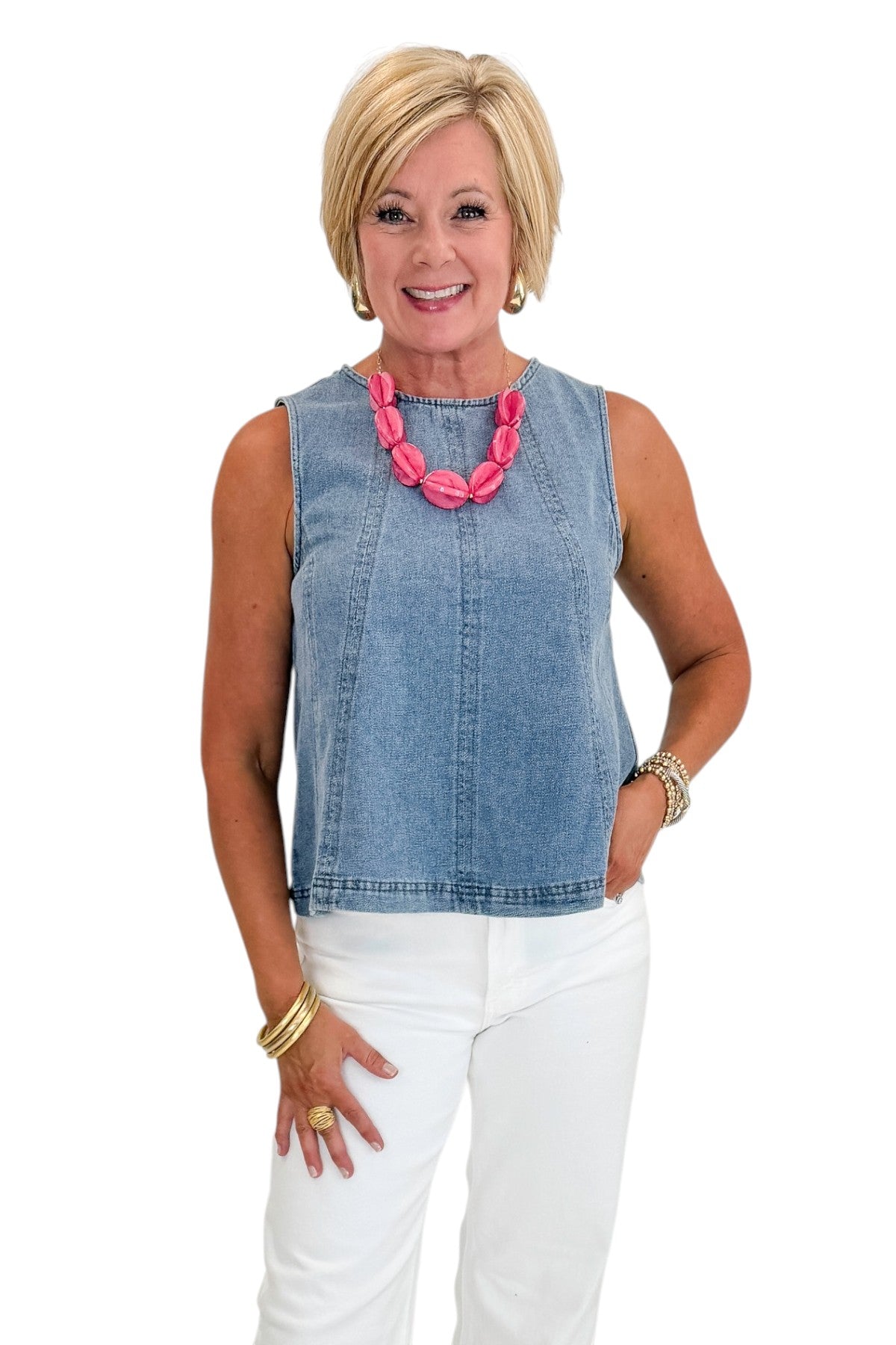 Front view of woman wearing Swagger Boutique’s Denim Seamed Sleeveless Top with jeans against white studio background.