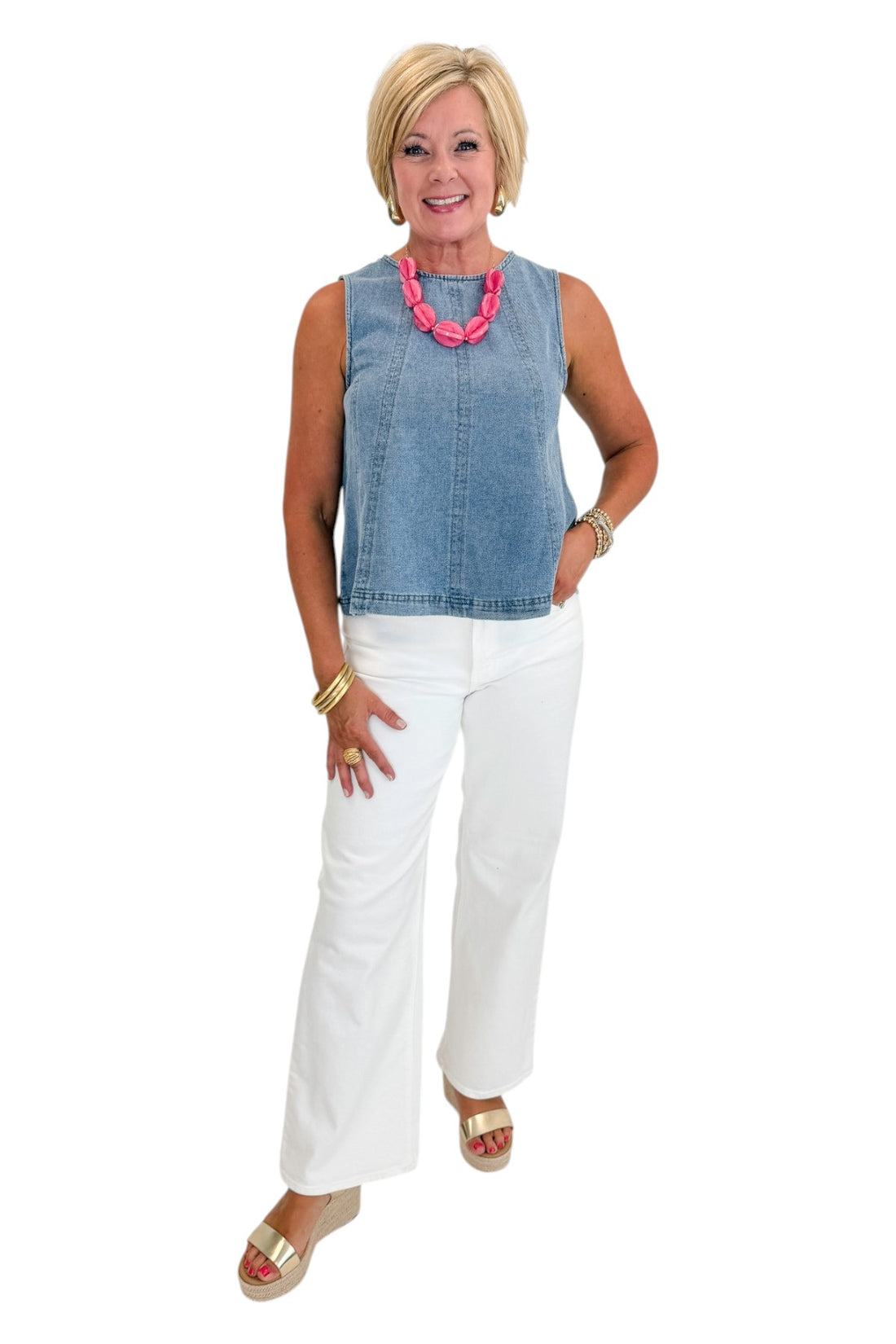 Front view of woman wearing Swagger Boutique’s Denim Seamed Sleeveless Top with jeans against white studio background.