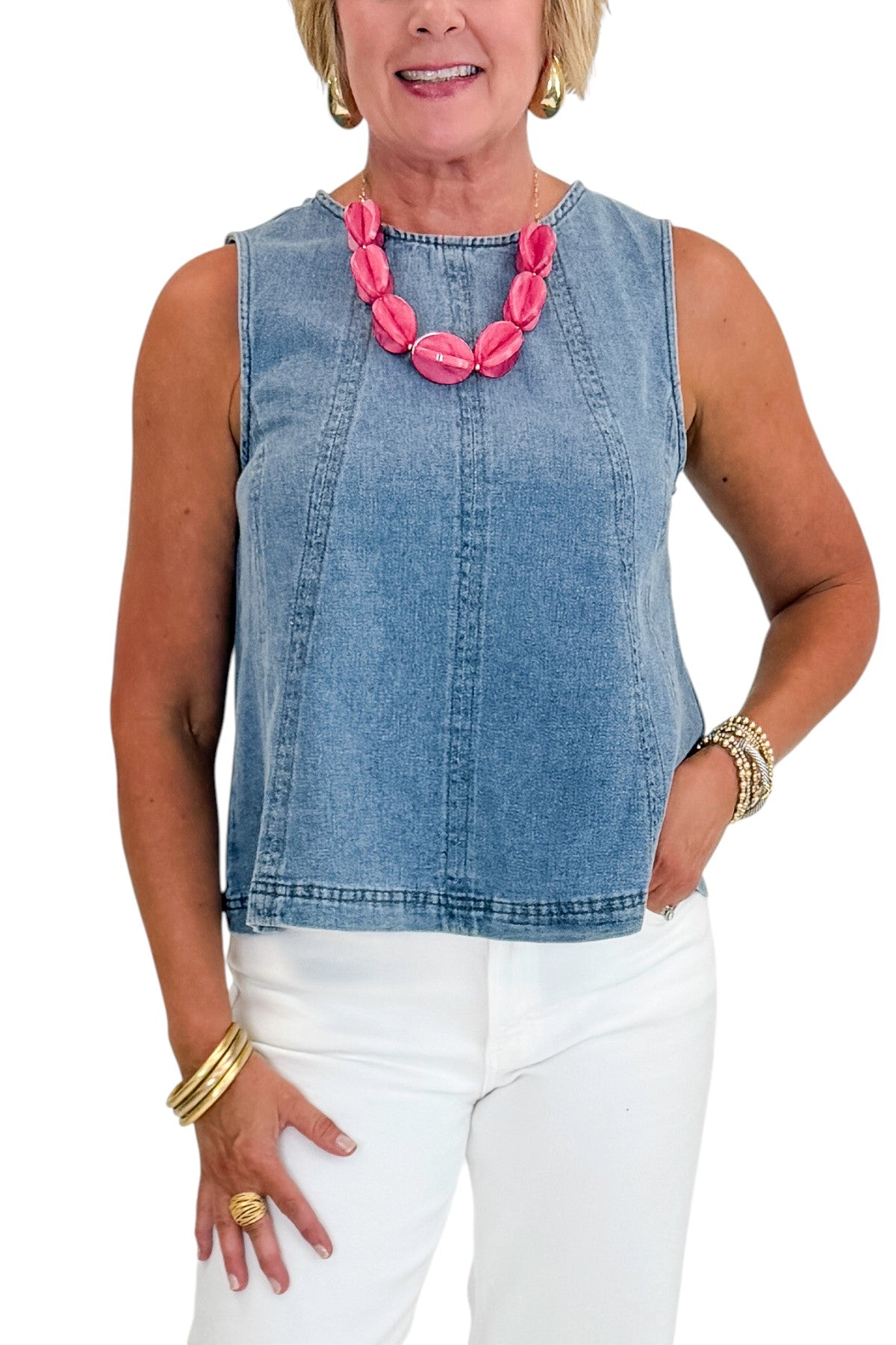 Front detail view of woman wearing Swagger Boutique’s Denim Seamed Sleeveless Top with jeans against white studio background.