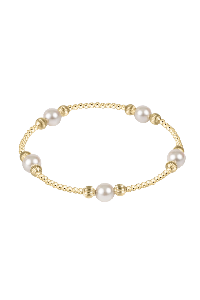 Gold bracelet with pearls on a white background