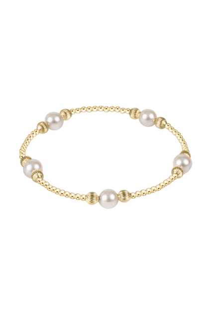 Gold bracelet with pearls on a white background