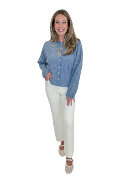 Front view of woman wearing Swagger Boutique’s Dusty Blue Button Up Cardigan with jeans against white studio background.