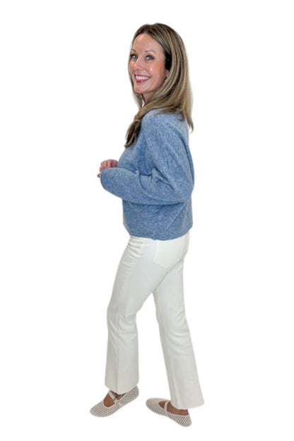 Side view of woman wearing Swagger Boutique’s Dusty Blue Button Up Cardigan with jeans against white studio background.