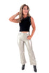Front view of woman wearing silver coated jeans black top against white studio background.