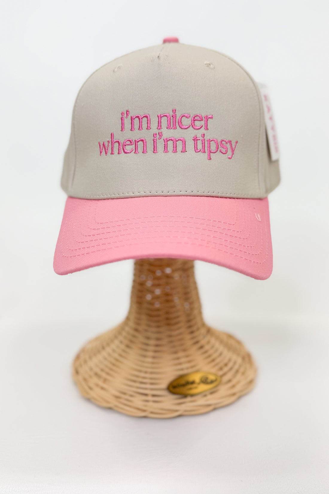 Beige and pink cap with text on a white background