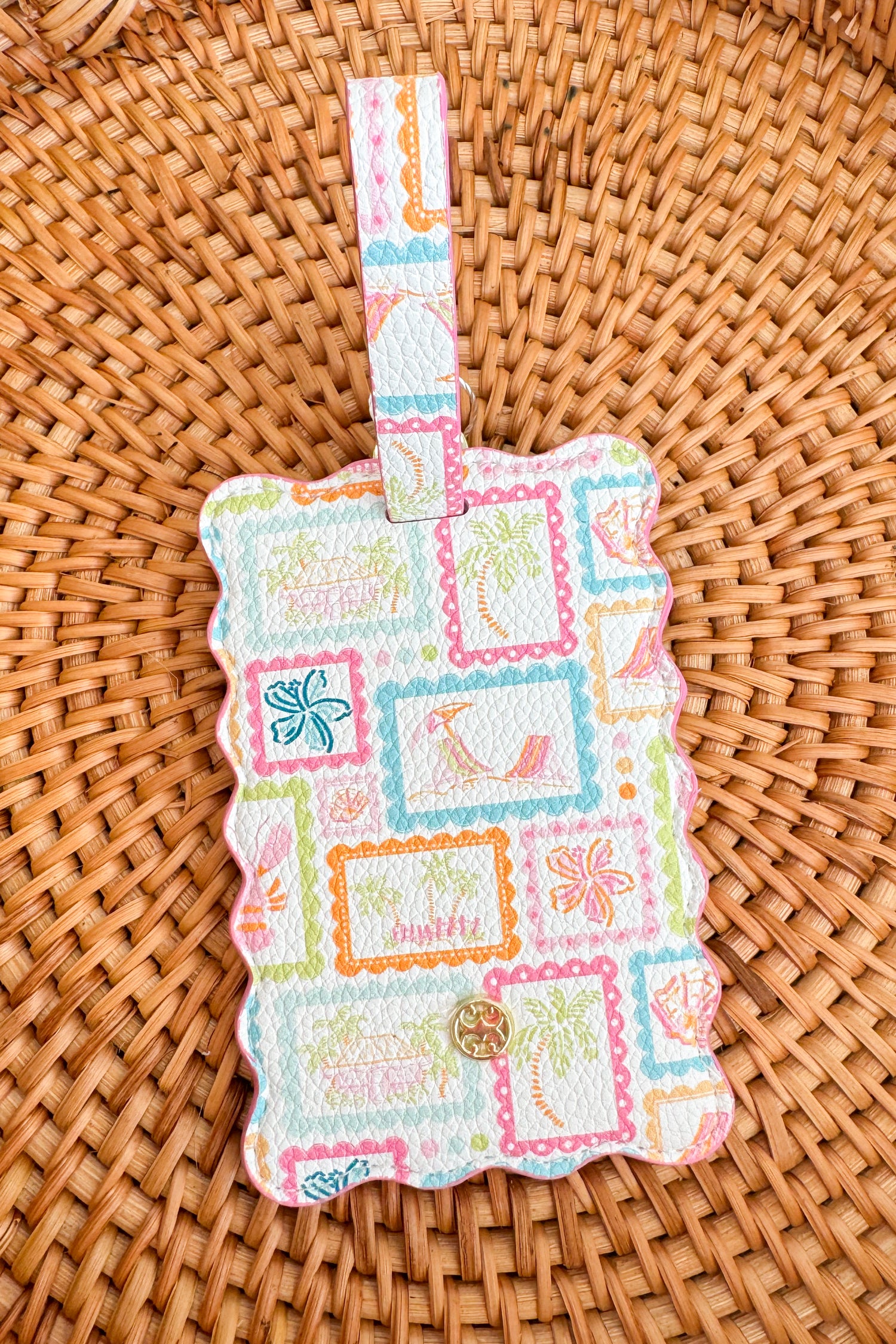 Colorful patchwork-style luggage tag on a woven surface