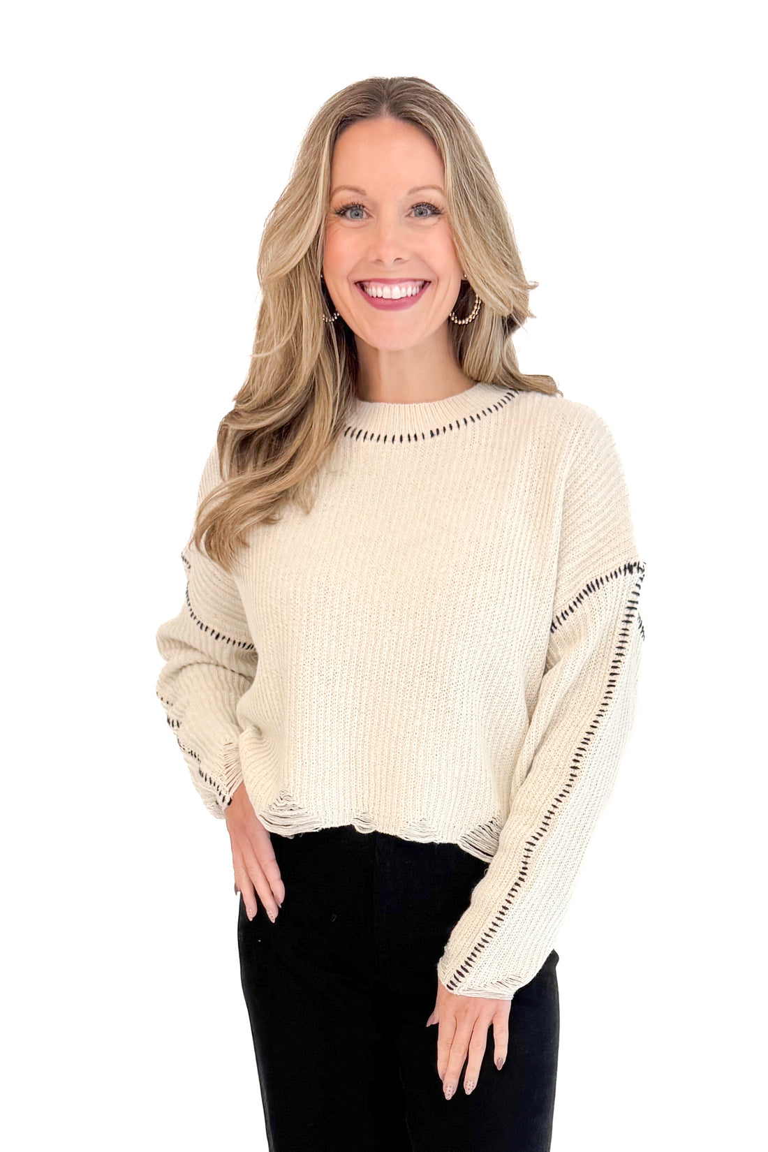 Front view of woman wearing stitch detail oatmeal sweater.
