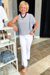 Front view of woman wearing Navy & Ivory Striped Asymmetrical Ruffle Top with jeans and sandals at Swagger boutique