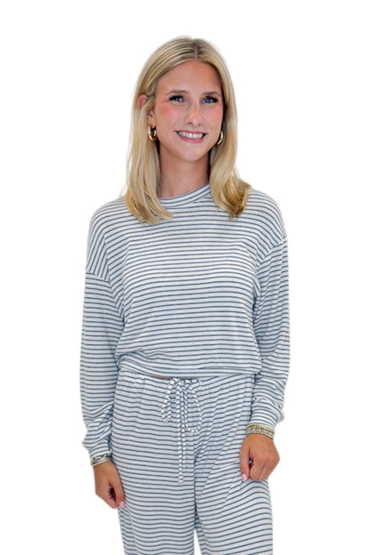 Front view of woman wearing Swagger Boutique’s Eclipse Classic Stripe Pants by Z Supply with Long Sleeve Top against white studio background.