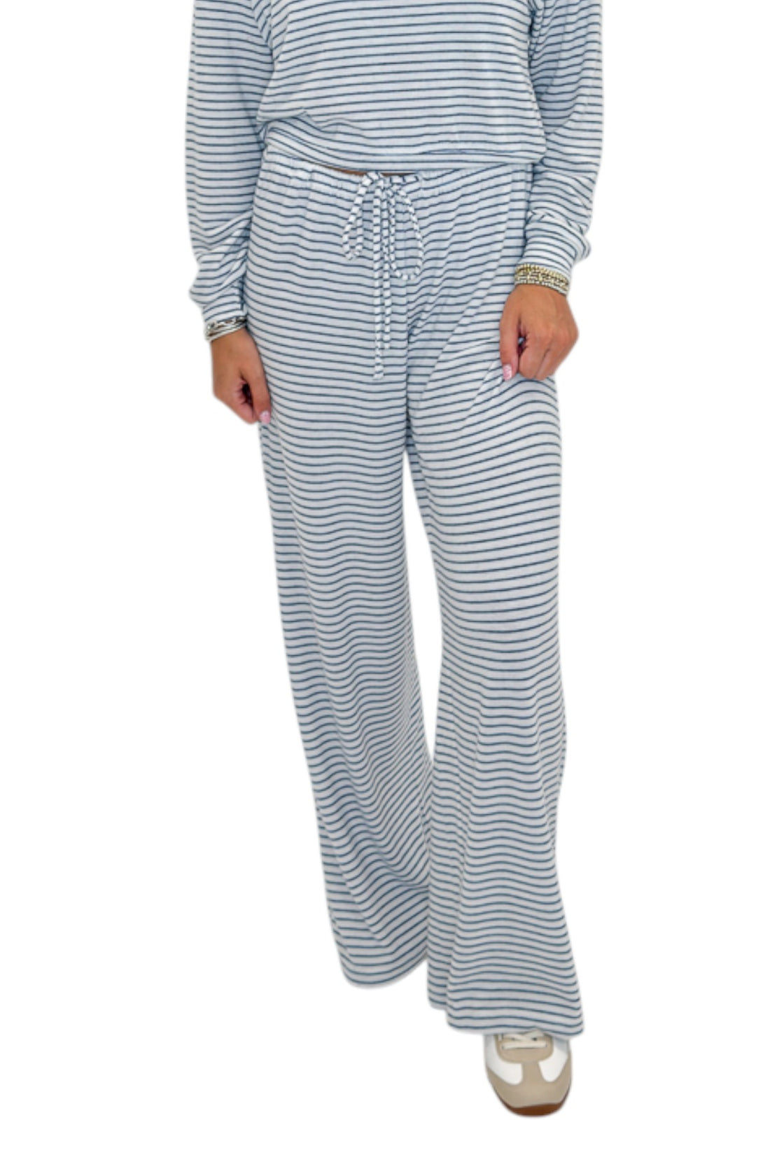 Front view of woman wearing Swagger Boutique’s Eclipse Classic Stripe Pants by Z Supply with Long Sleeve Top against white studio background.