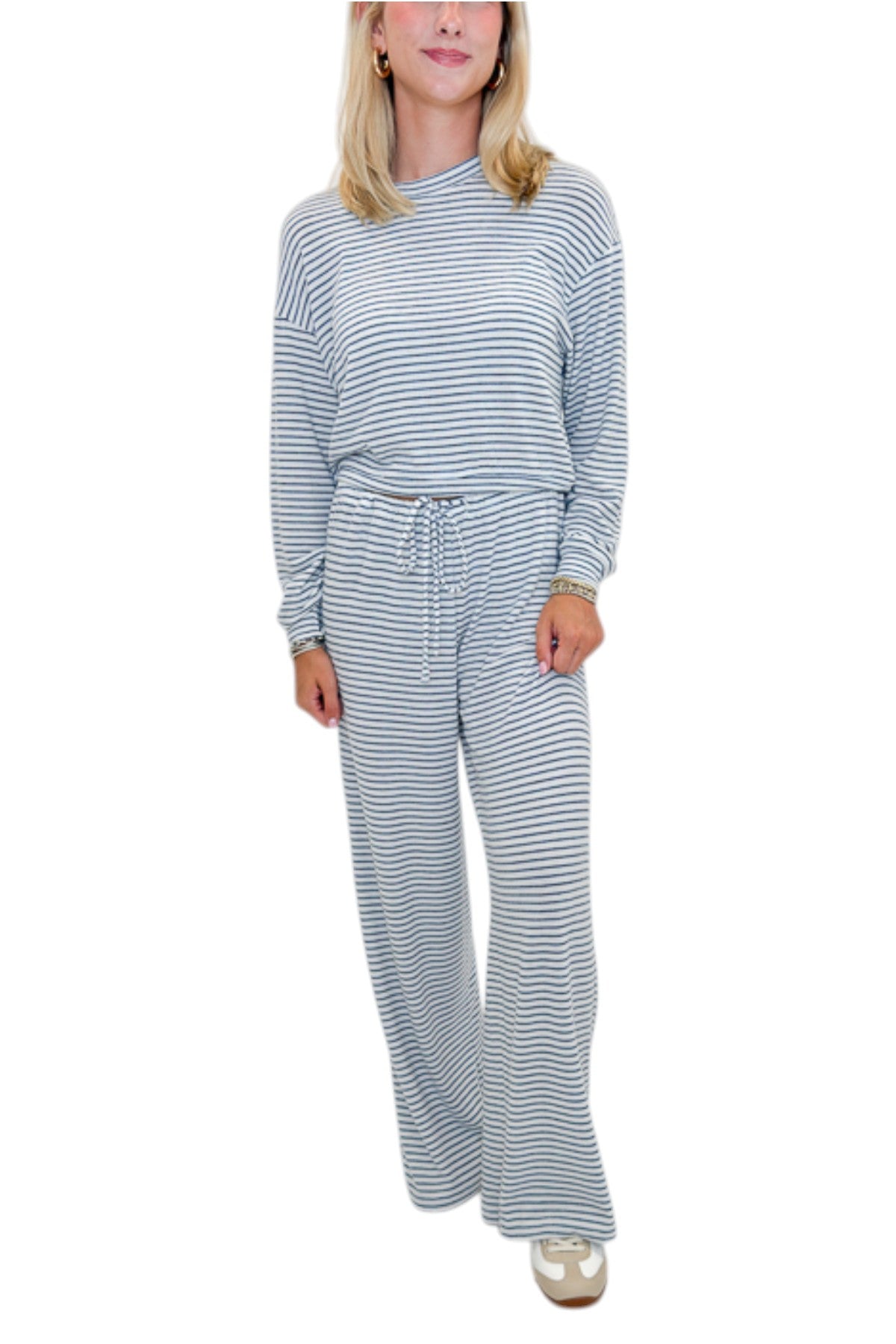 Front view of woman wearing Swagger Boutique’s Eclipse Classic Stripe Pants by Z Supply with Long Sleeve Top against white studio background.