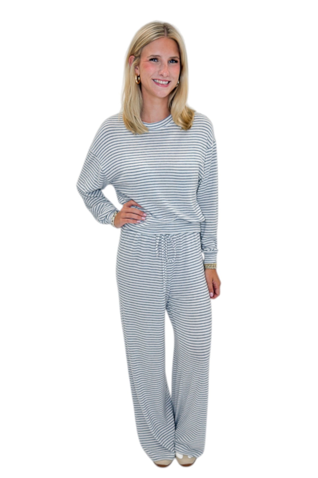 Front view of woman wearing Swagger Boutique’s Eclipse Classic Stripe Pants by Z Supply with Long Sleeve Top against white studio background.