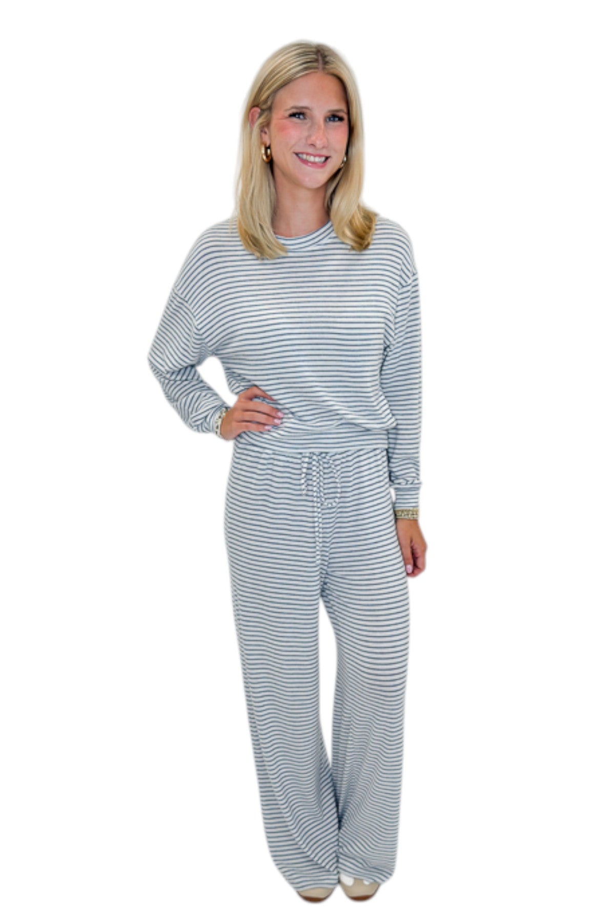 Front view of woman wearing Swagger Boutique’s Eclipse Classic Stripe Pants by Z Supply with Long Sleeve Top against white studio background.